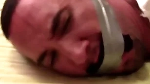 Victor sockgagged and tapegagged tight and captured with socks inside his mouth wrapped the remain effective wide his head preview