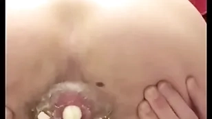 Cute teen pushes boiled egg at large of his ass